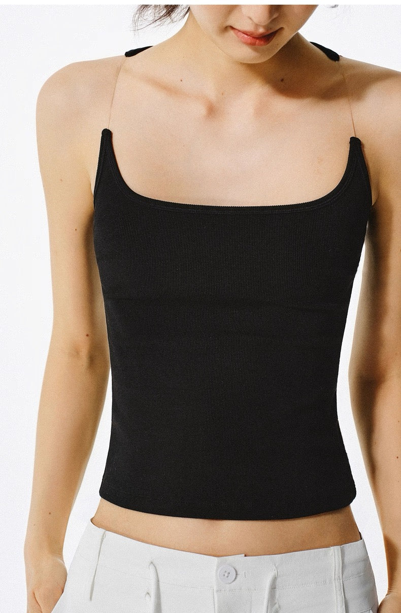 Person wearing a black tank top on a white background