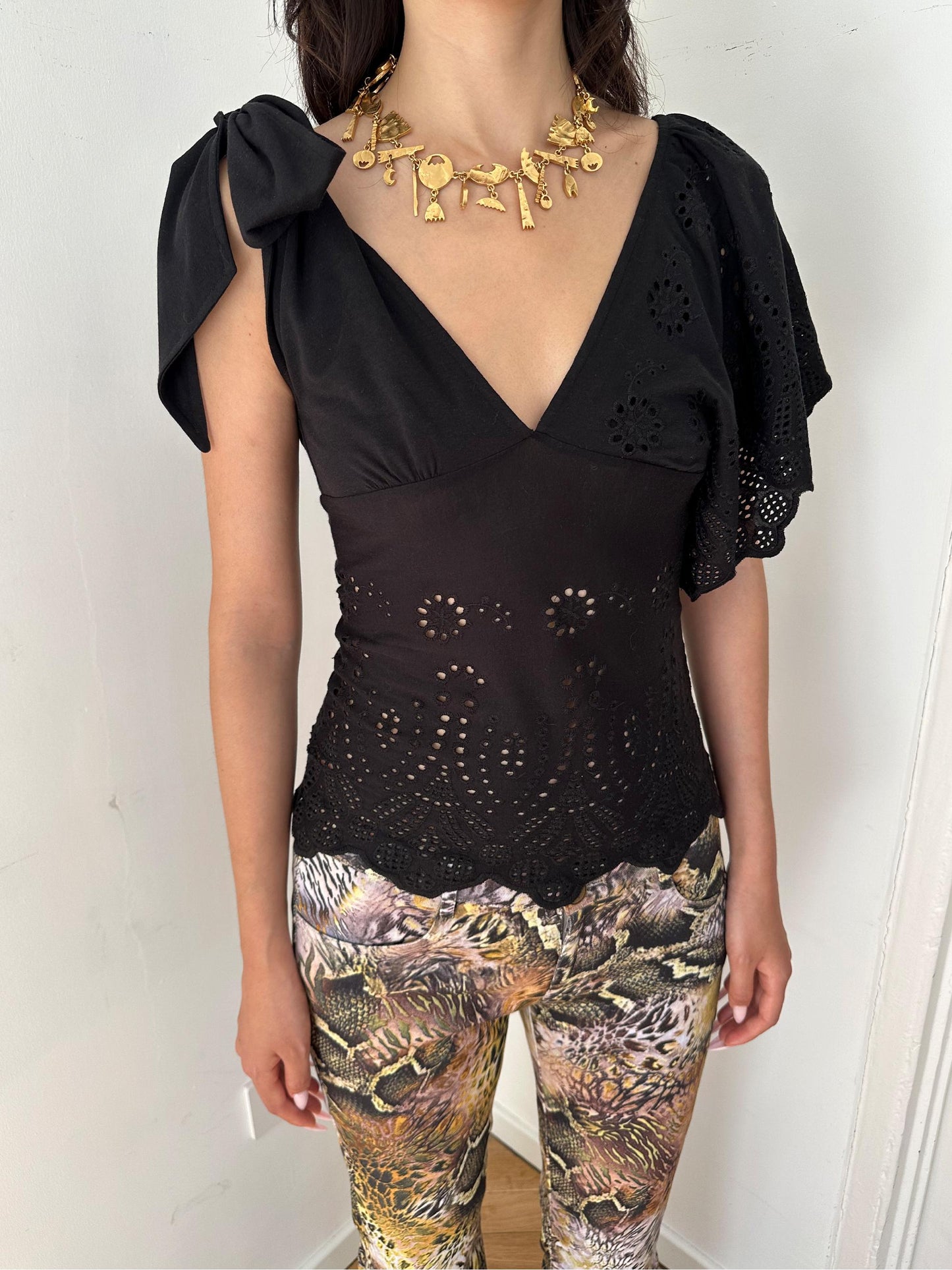 Front view angle showing asymmetrical shoulder design and slim fit shape.