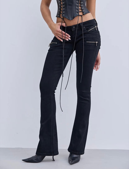 Black flared jeans with lace-up details on a white background