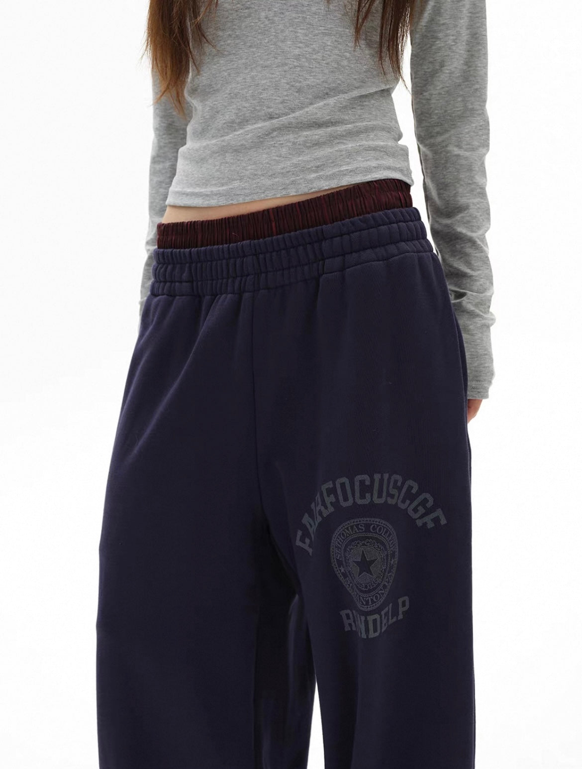 Navy sweatpants with a logo and text on a white background