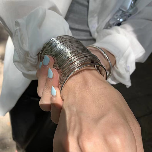 close up of cuff bracelet showing the little details like how the sun reflects off it.