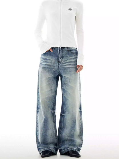 Person wearing a white long-sleeve shirt and blue jeans on a white background