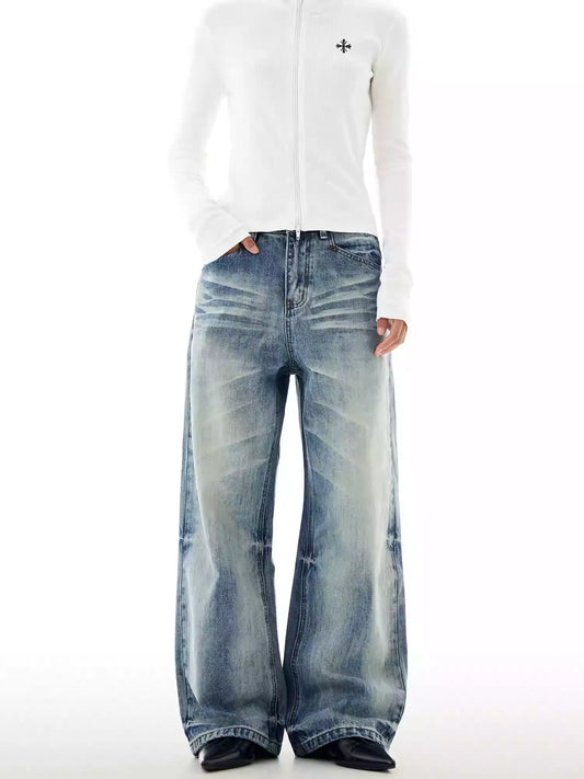 Person wearing a white long-sleeve shirt and blue jeans on a white background